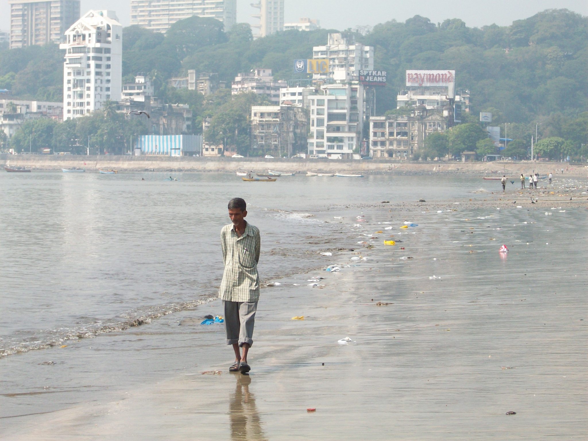 Unemployed Man On Dirty Beach In Mumbai