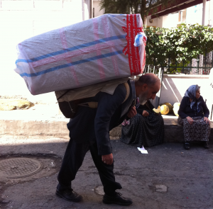 old-man-carry-load Old Man Carrying A Heavy Load